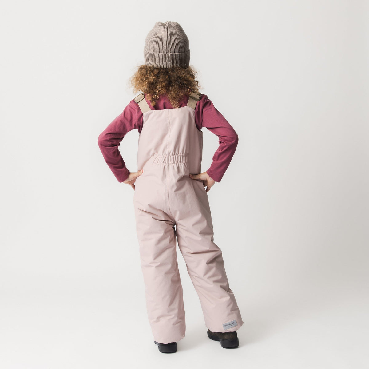 Child wearing MINI A TURE MATWALENTEX snow pants - Adobe Rose - back